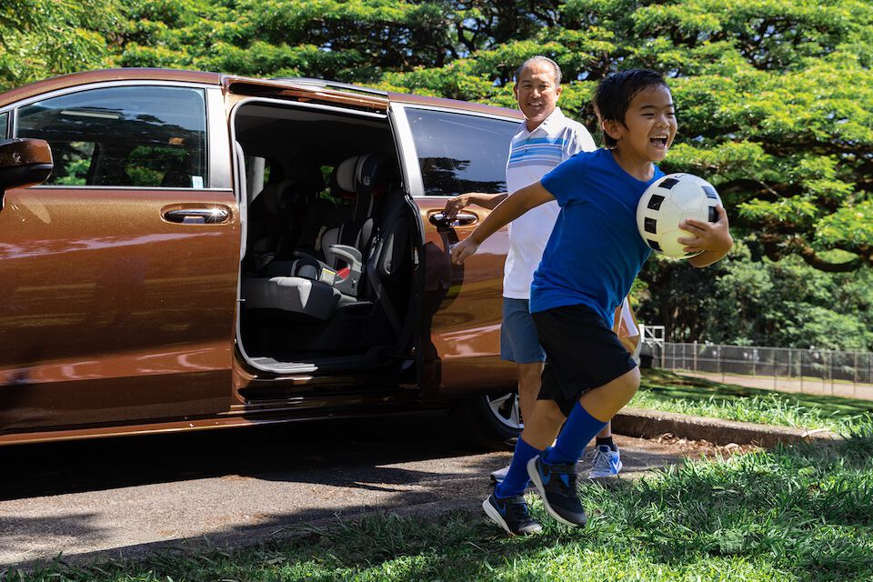 Father and son eagerly arrive at soccer practice