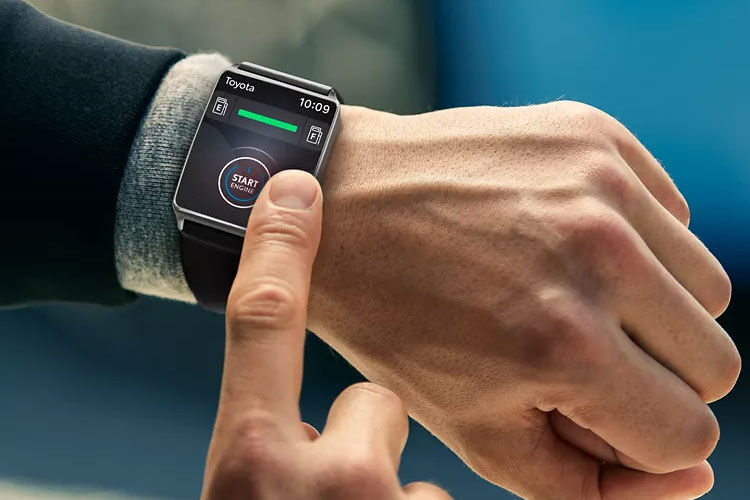 Close up of model's wrist, programming a smartwatch.