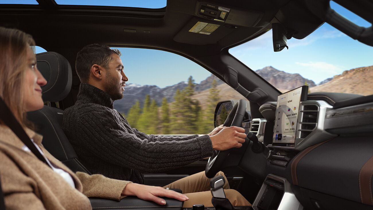 Toyota Sequoia Capstone&rsquo;s interior with a young couple driving through the mountains.