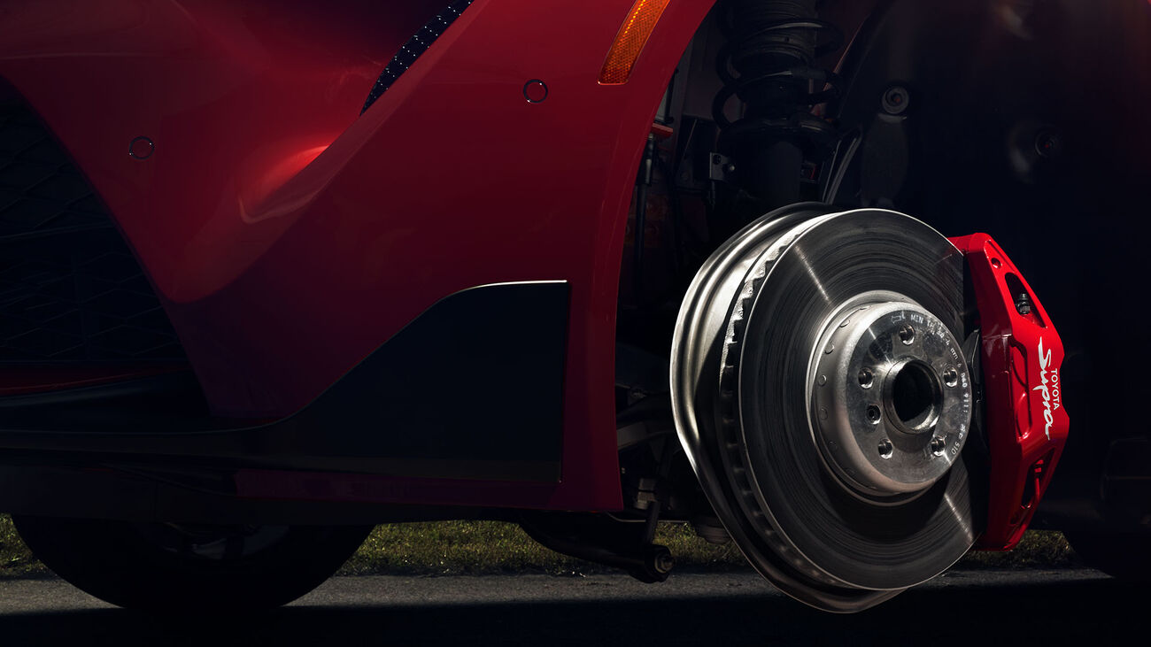 GR Supra&rsquo;s Brembo Performance Brake system with red brake calipers.