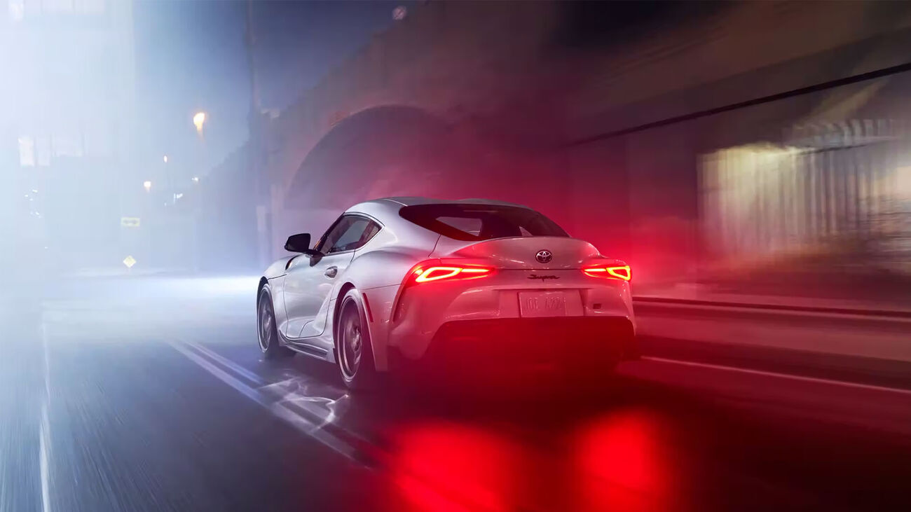 GR Supra 3.0 Premium in Absolute Zero driving along on a city street