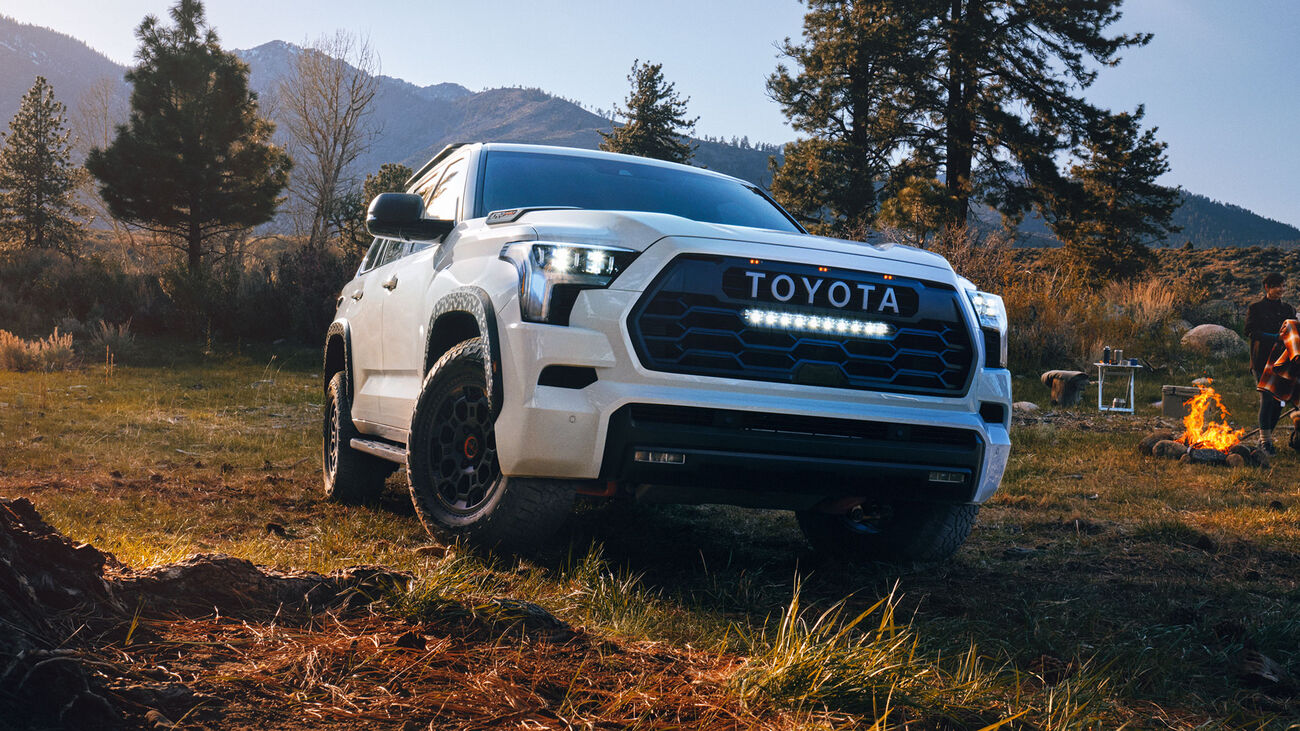 2026 Toyota Sequoia parked next to a campsite with a campfire going.