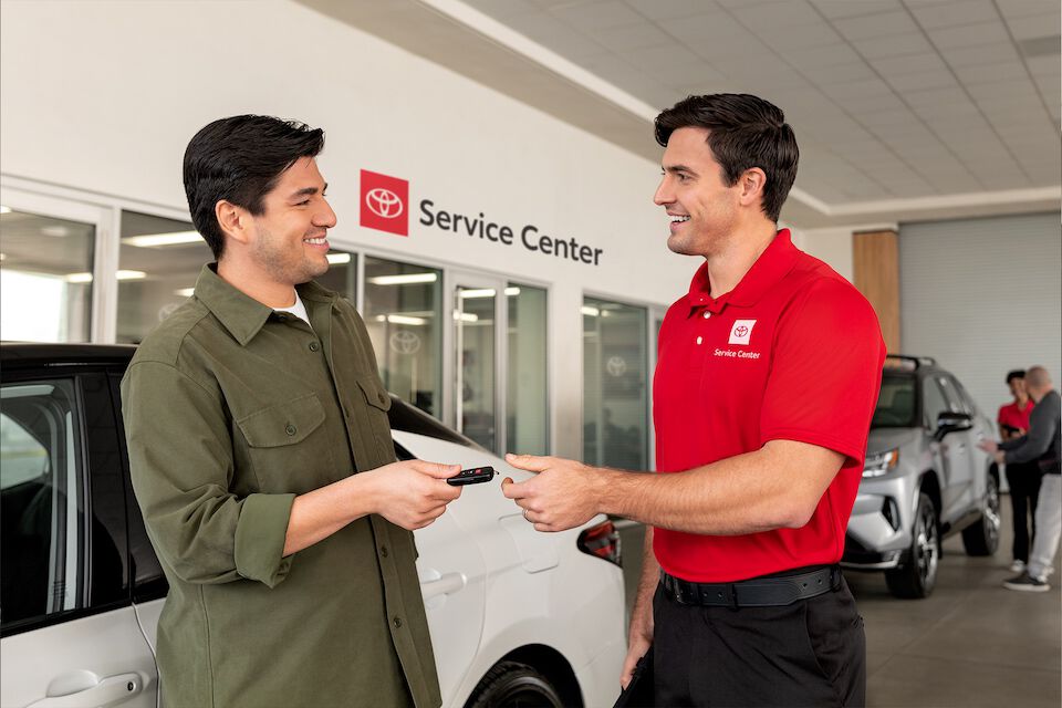 Customer hands keys to service specialist for service