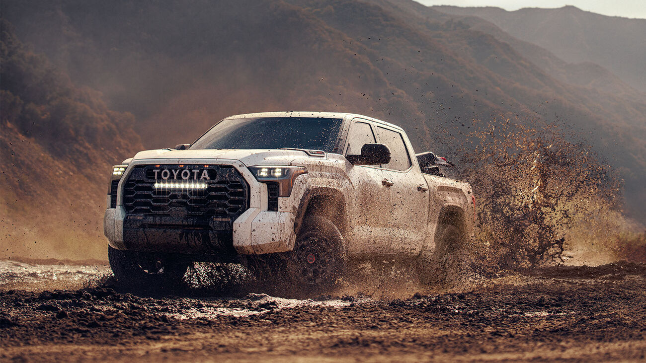 Toyota Tundra i-FORCE MAX TRD Pro in Ice Cap performing in an open mudpatch.