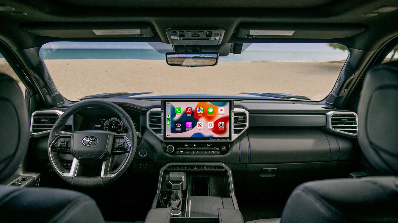 Toyota Tundra i-FORCE MAX Platinum in Blueprint&rsquo;s specially crafted interior with a view of a white sandy beach and crystal clear blue water.