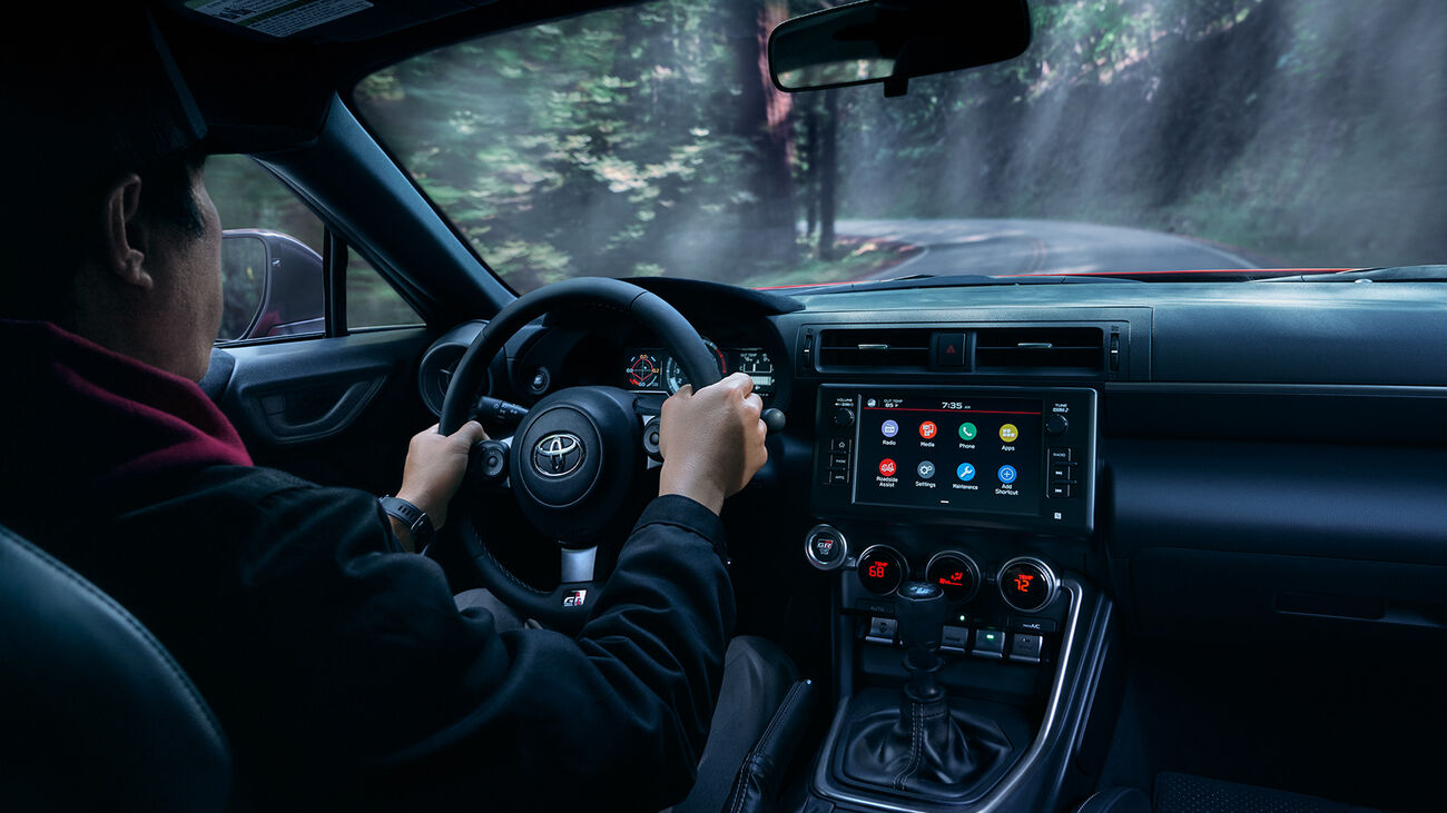 Individual driving the Toyota GR86 Premium in Track bRED up a curvy mountain road