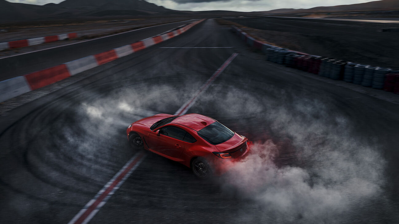 Toyota GR86 performing on a racetrack with available Brembo&reg; brakes and performance suspension.